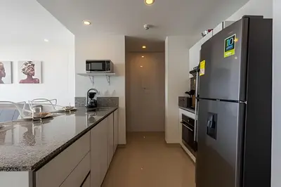 a kitchen with a refrigerator and a counter top at 1004 Morros City - Spectacular 1 Bedroom Condo in Cartagena de Indias