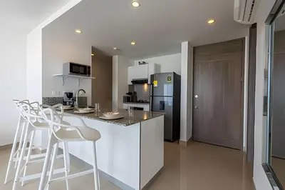 a kitchen with a counter and a refrigerator at 1004 Morros City - Spectacular 1 Bedroom Condo in Cartagena de Indias