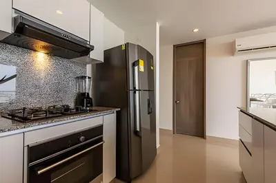 a kitchen with a stove and a refrigerator at 1004 Morros City - Spectacular 1 Bedroom Condo in Cartagena de Indias