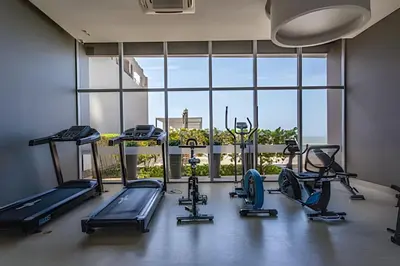 a gym with several tread machines and a large window at Hermoso Apto 2 Hab Piso 11 en Morros City in Cartagena de Indias