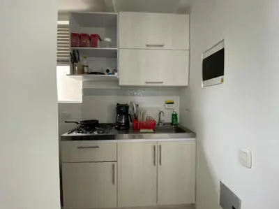 a small kitchen with white cabinets and a stove at Apartamento Playas de Marbella in Cartagena de Indias