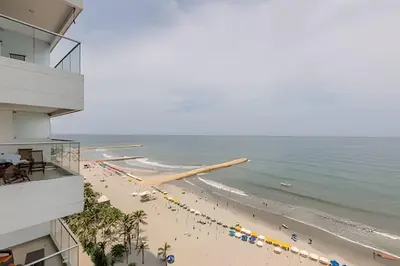 a view of the beach from the balcony of a building at Espectacular Apto 3 Hab Palmetto Beach 1201 in Cartagena de Indias