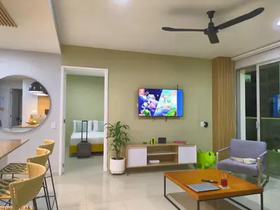 a living room with a tv on a wall at Bizsar Mar 4 Piscinas Acceso privado playa BBQ privado in Cartagena de Indias