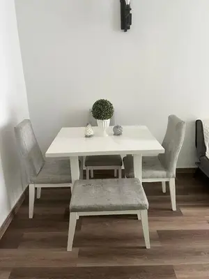 a white table and chairs with a vase on it at Casa Ingrid in Cartagena de Indias