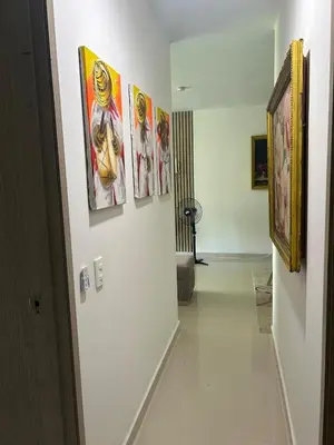 a hallway with paintings on the walls of a room at Confortable Apartamento in Barranquilla