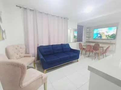 a living room with a blue couch and a table at A 20 min CC Vista vista con patio fácil acceso in Barranquilla