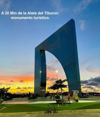 a large glass building with an arch in front of it at A 20 min CC Vista vista con patio fácil acceso in Barranquilla
