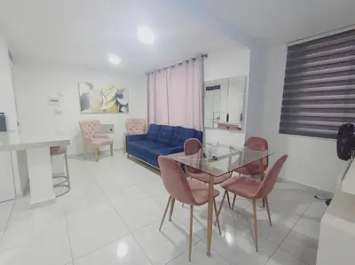 a living room with a glass table and a blue couch at A 20 min CC Vista vista con patio fácil acceso in Barranquilla