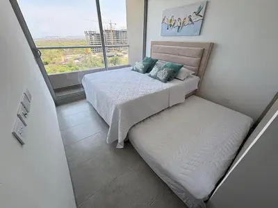 a small bedroom with a bed and a window at Apartasuite x4 Playa Piscina Jacuzzi Zona Decameron Santa Marta in Santa Marta