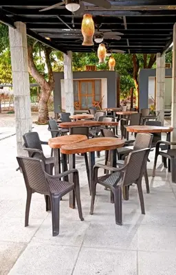 a group of tables and chairs in a restaurant at Mango Beach in San Bernardo del Viento