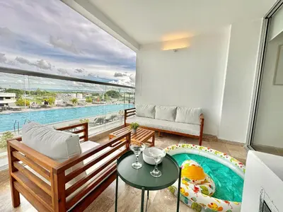 a living room with a pool view from a balcony at Suite Familiar + Piscinita + Vista Piscina CB536 in Cartagena de Indias