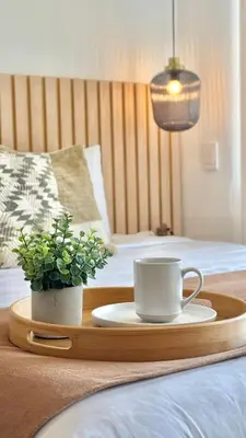 a tray with a coffee cup and a plant on a bed at Suite Familiar + Piscinita + Vista Piscina CB536 in Cartagena de Indias