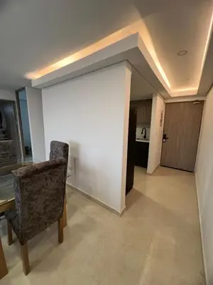 a living room with a table and chairs and a wall at Apartment 5 minutes from the Airport, Sea and Center in Cartagena de Indias
