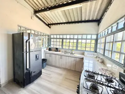 a kitchen with a refrigerator and a stove in it at Playa Virginia Beach House Privada in San Silvestre
