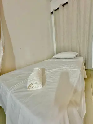 a white bed with a towel on top of it at Playa Virginia Beach House Privada in San Silvestre