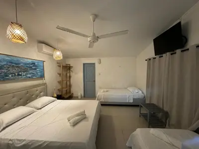 a bedroom with two beds and a ceiling fan at Playa Virginia Beach House Privada in San Silvestre