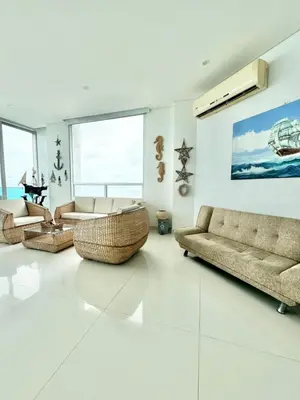 a living room with two couches and a couch at Apartamento de lujo frente al mar in Coveñas