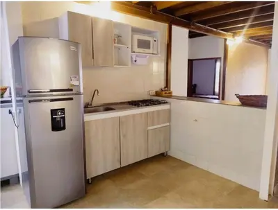 a kitchen with a refrigerator and a sink at Tu paraíso frente al mar te espera en Santa Verónica in Tubará