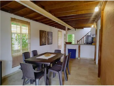 a dining room with a wooden table and chairs at Tu paraíso frente al mar te espera en Santa Verónica in Tubará