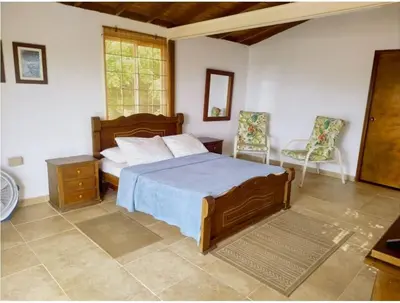 a bedroom with a bed and a table and a chair at Tu paraíso frente al mar te espera en Santa Verónica in Tubará