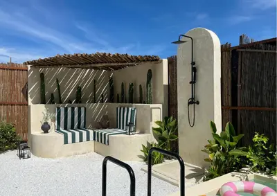 a patio with two chairs and a fence at Villa CANGGU- Villa con piscina privada, estilo mediterraneo in Tubará