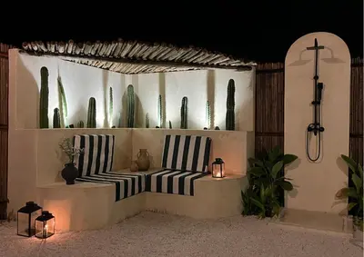 a room with two benches and cactuses and plants at Villa CANGGU- Villa con piscina privada, estilo mediterraneo in Tubará