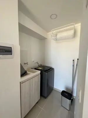 a small bathroom with a sink and a air conditioner at Modern Apartment in Barranquilla in Barranquilla