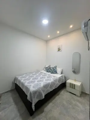 a bedroom with a bed and a small table at Tu casa en cartagena in Cartagena de Indias
