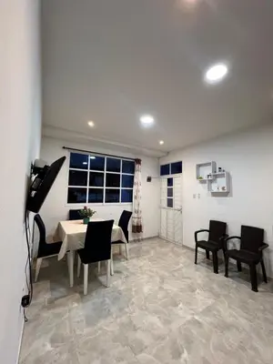 a dining room with a table and chairs and a window at Tu casa en cartagena in Cartagena de Indias