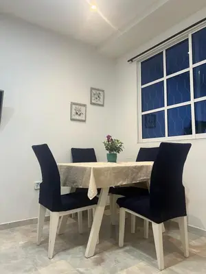 a dining room table with chairs and a window at Tu casa en cartagena in Cartagena de Indias