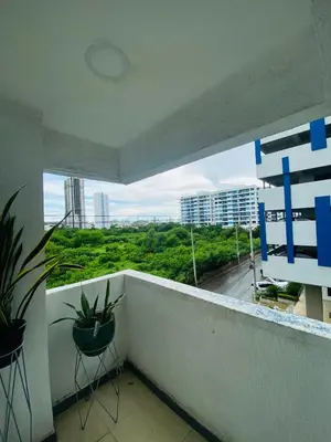 a balcony with two chairs and a view of a city at Apartamento Los Lagos in Cartagena de Indias