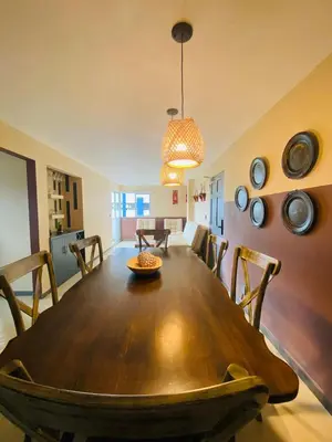 a dining room with a wooden table and chairs at Apartamento Los Lagos in Cartagena de Indias