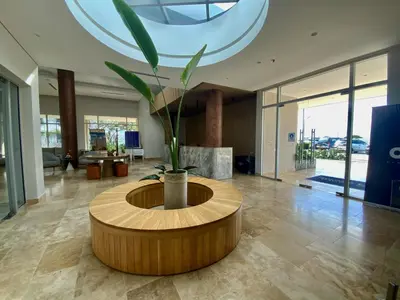 a round table with a plant in the middle of a room at VISTA BAHIA Santa Marina Santa Marta in Santa Marta