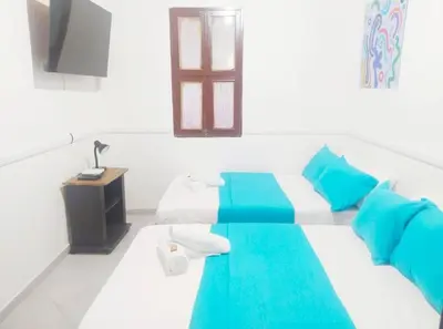 a room with a bed with blue and white at Acogedor apto en el centro historico - CER in Cartagena de Indias