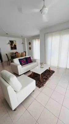 a living room with a white couch and a table at Casa a 2 minutos de la playa en playa mendoza in Tubará