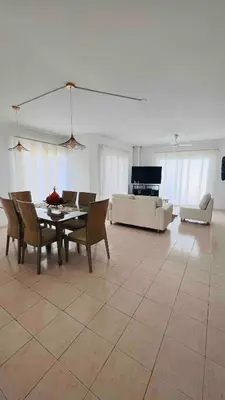 a living room with a table and chairs and a couch at Casa a 2 minutos de la playa en playa mendoza in Tubará