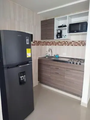 a kitchen with a black refrigerator and a sink at Cartagena Search in the Historic Center T6 in Cartagena de Indias