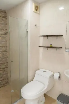 a bathroom with a toilet and a glass shower at Cartagena Search in the Historic Center T6 in Cartagena de Indias