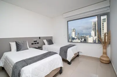 a hotel room with two beds and a window at Luxury-Ocean view apartment in Bocagrande in Cartagena de Indias