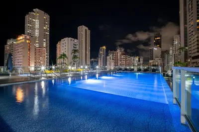 a large swimming pool in a city at night at Luxury-Ocean view apartment in Bocagrande in Cartagena de Indias