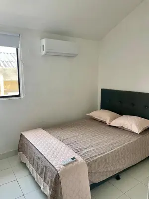 a small bed in a room with a window at Oceanfront accommodation! in Cartagena de Indias