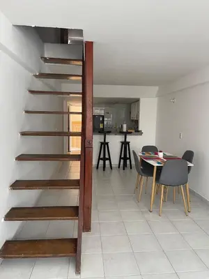 a staircase in a room with a table and chairs at Oceanfront accommodation! in Cartagena de Indias
