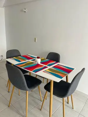 a dining room table with chairs and a colorful table at Oceanfront accommodation! in Cartagena de Indias
