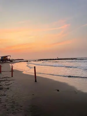 a beach with red poles in the sand and the ocean at Oceanfront accommodation! in Cartagena de Indias
