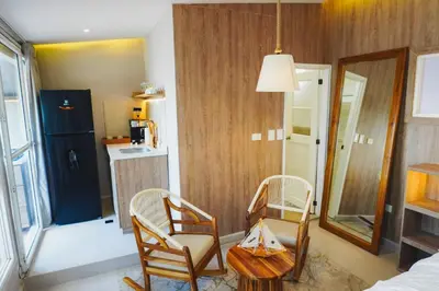 a living room with two chairs and a table at Suite Premium con Terraza y Jacuzzi Privado in Cartagena de Indias