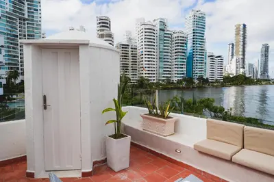 a white building on a balcony with a view of a city at Suite Premium con Terraza y Jacuzzi Privado in Cartagena de Indias