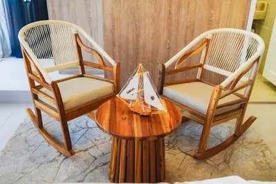 two chairs and a table with a bag on it at Suite Premium con Terraza y Jacuzzi Privado in Cartagena de Indias