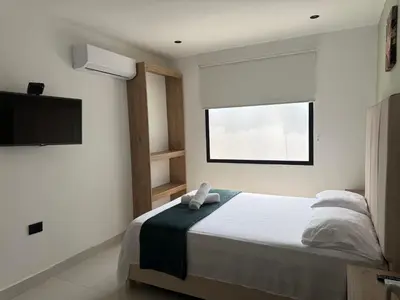 a bedroom with a bed and a television in it at Arcadia Hotel in Cartagena de Indias