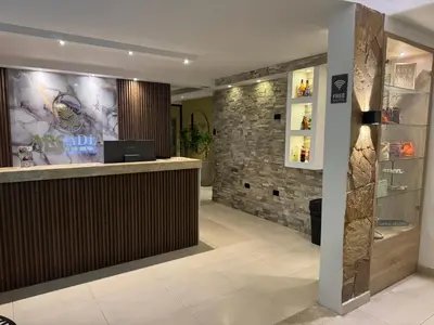 a bar in a hotel lobby with a stone wall at Arcadia Hotel in Cartagena de Indias