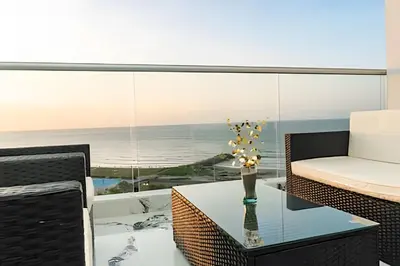 a living room with a glass table and a couch at Escape to Paradise - Oceanfront in Cartagena in Cartagena de Indias